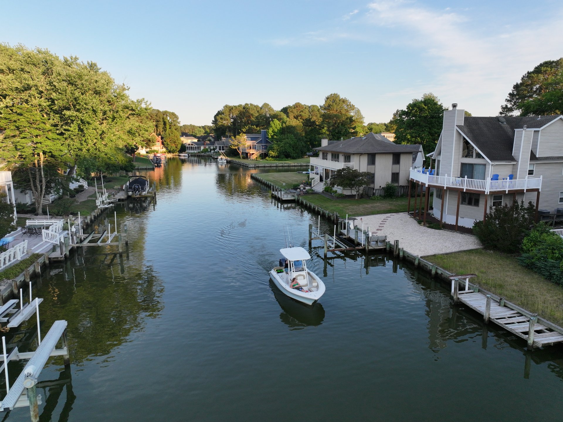 Boat cruising a residential canal community